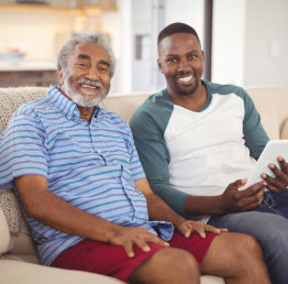 caregiver and a senior man smiling