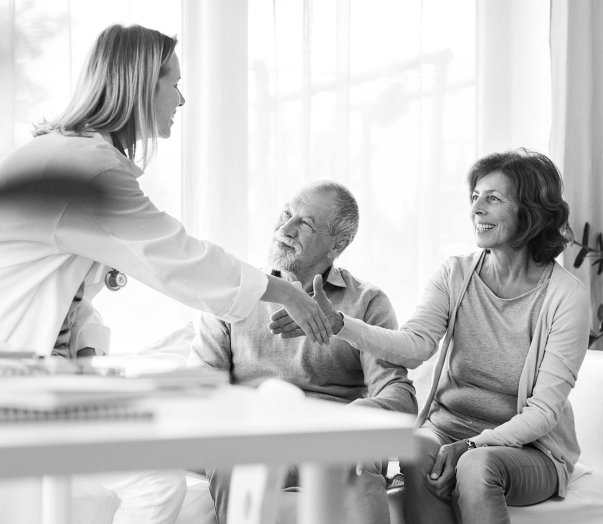 elderly couple having a nice talk to a doctor