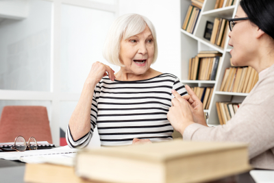 senior woman talking to a caregiver