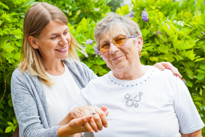 caregiver holding the hand of a senior