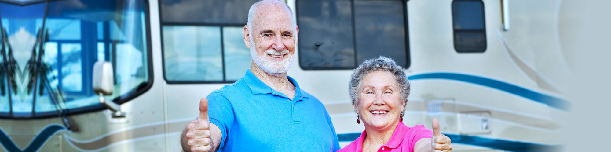 senior couple doing thumbs up