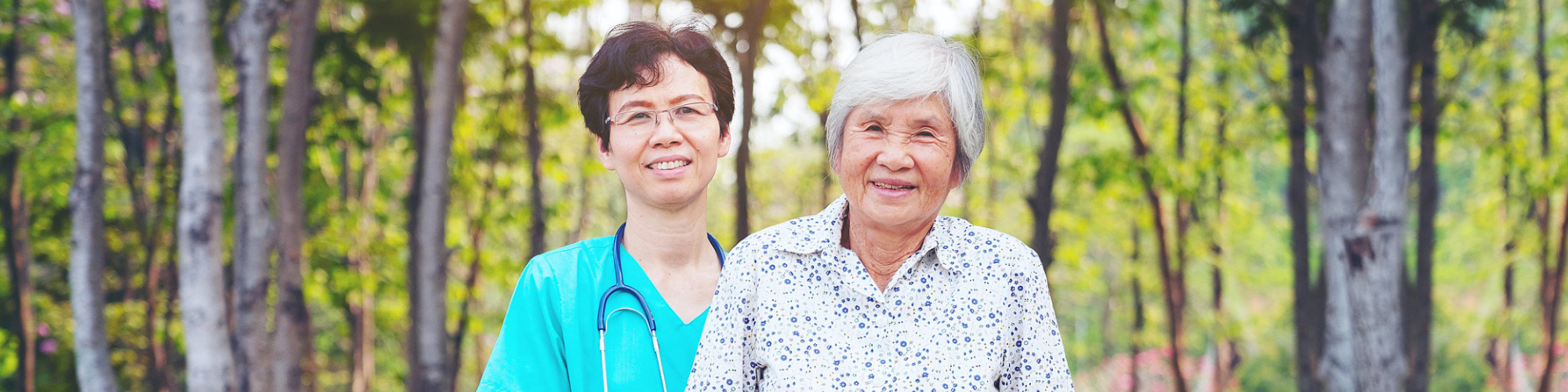senior woman and a caregiver smiling