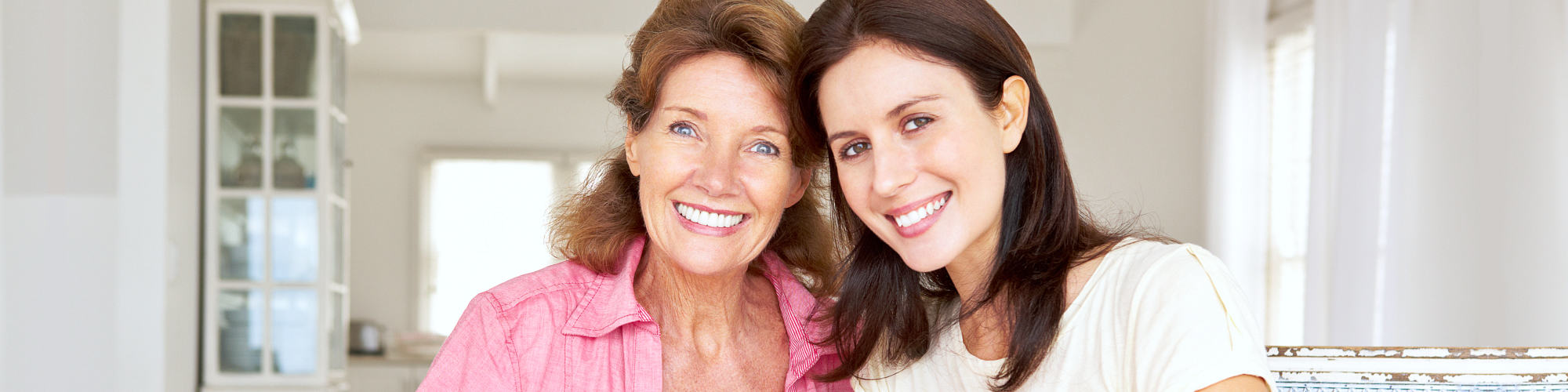 caregiver and a senior woman smiling