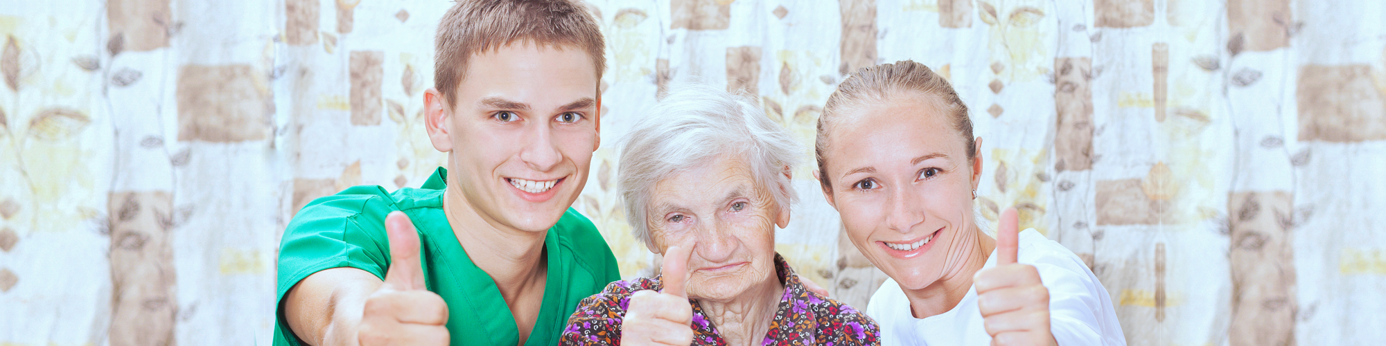 two caregiver and a senior doing thumbs up