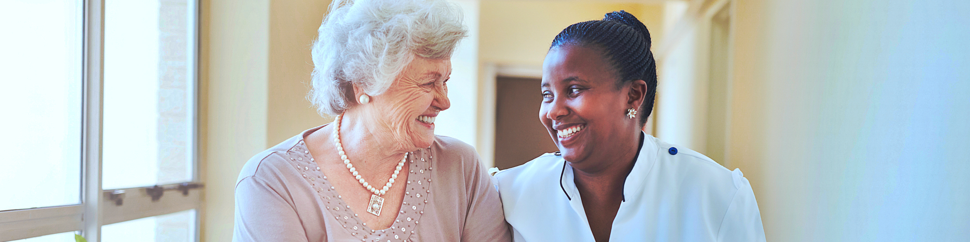 caregiver and a senior smiling